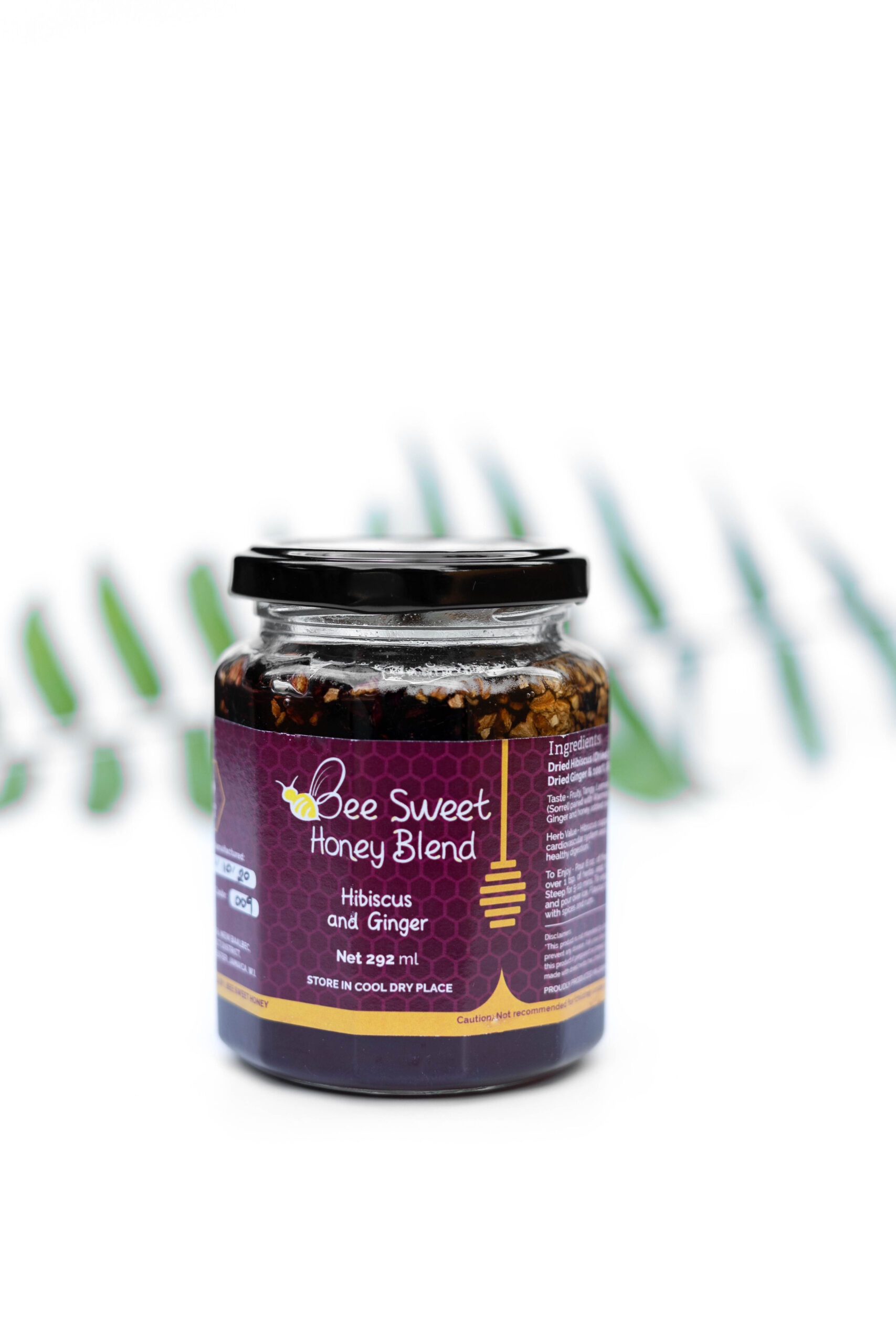 Bee Sweet Hibiscus and Ginger Honey Blend- glass jar with Hibiscus and Ginger pieces in Jamaican honey.